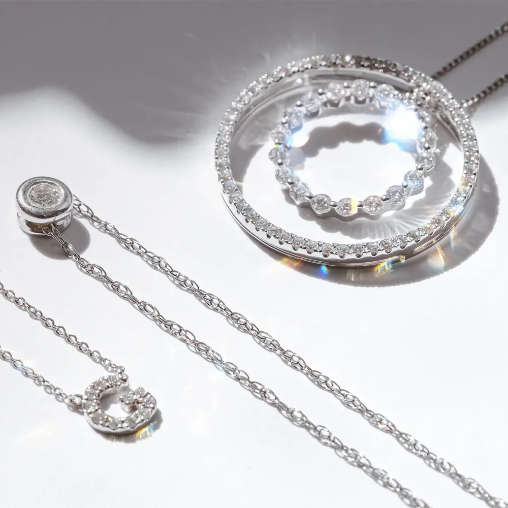 Bespoke circle diamond pendants in white gold